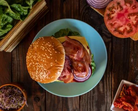 Hamburger and ingredients in composition Stock Photos