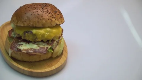 Hamburger with beef and cheddar on white background. Stock Footage 80565844
