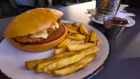 Hamburger with breaded chicken, vegetables and drink, served with French fries Stock Footage 269912913