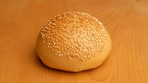 Hamburger buns cut into two pieces using a knife. Stock Footage 107620110