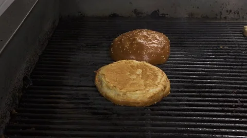 Hamburger buns on the grill Stock Footage 69871278