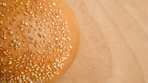 Hamburger buns on the table.  Bun rotates in a circle on a wooden stand. Stock Footage 107620137