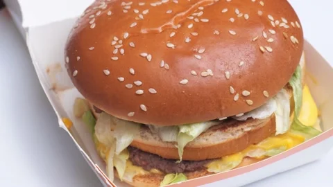 Hamburger close-up rotates in a circle Stock Footage 228845465