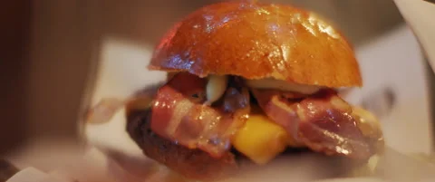 Hamburger with fried bacon strips Stock Footage 152583124