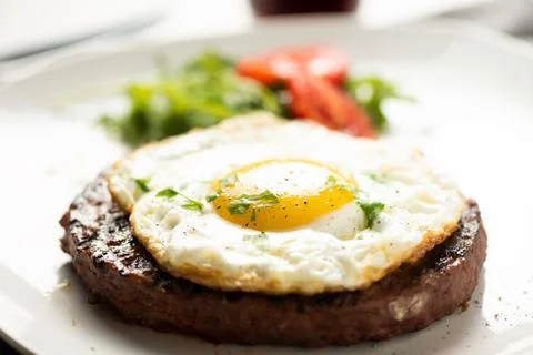 Hamburger with fried egg closeup Stock Photos