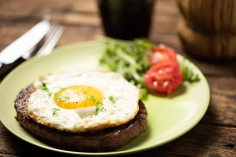Hamburger with fried egg closeup Stock Photos