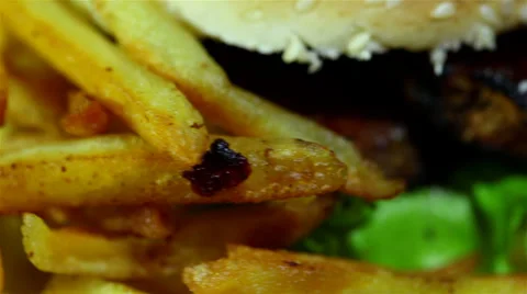 Hamburger with fried potato in rotation. Macro Video stock 35995089