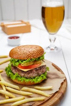 Hamburger with grilled marbled beef, tomato, cheese, salad and fries Stock Photos