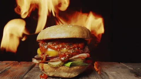 Hamburger Grilled over Open Flames on a Rustic Wooden Table 库存影片 331101340