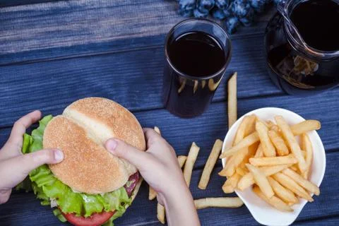 Hamburger in hands top view Stock Photos
