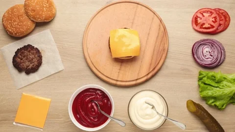 Hamburger ingredients assembling a delicious burger, stop motion Stock Footage 147581908