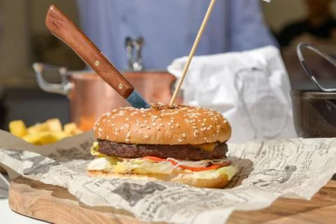 The hamburger with a knife Stock Photos