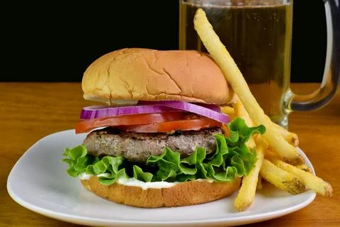 Hamburger  with lettuce, tomatoes and onions Stock Photos