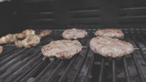 Hamburger meat grilling on BBQ Stock Footage 246697463