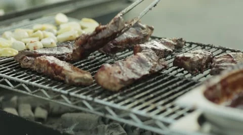 Hamburger patty on the grilling pan with open flames Stock Footage 64285153