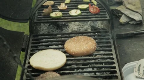 Hamburger patty on the grilling pan with open flames Stock Footage 64285273