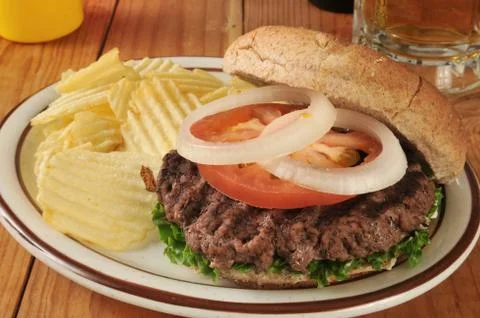 Hamburger with potato chips Stock Photos