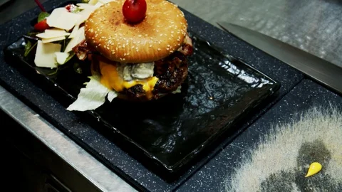 Hamburger  with salad moving camera slow motion Video stock 129109034