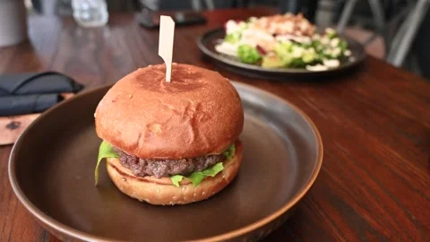 Hamburger served on the table in restaurant. Fast food. Stock Footage 271350916