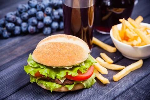 Hamburger on the table, grape juice Stock Photos