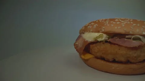 Hamburger on the white table. Slow panorama close-up. Food. Gradient background Stock Footage 132317053
