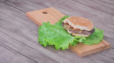 Hamburger on wooden background, stop motion, 4K Stock Footage 63008729