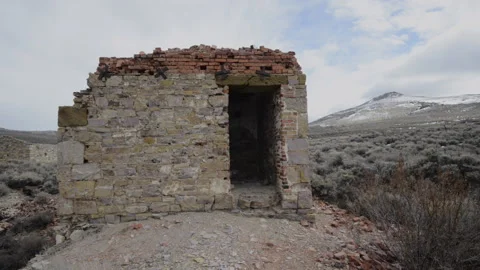 Hamilton, Nevada; a man exits an old bank vault in the ghost town of Hamilton Stock Footage 154775359