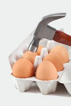 Hammer about to crack on egg Stock Photos