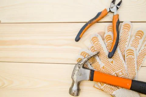 A hammer and protective work gloves Stock Photos