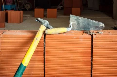 Hammer and trowel on construction site Stock Photos