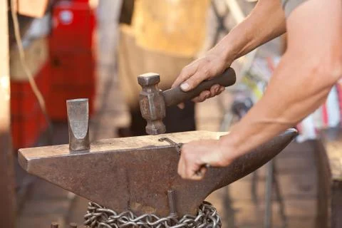 Hammer, anvil and the hands of a blacksmith 스톡 사진