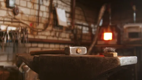 Hammer on the anvil in blacksmith workshop Stock Footage 125342199