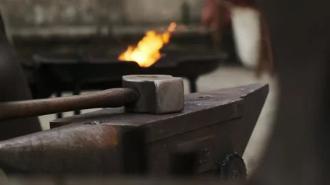 Hammer on Anvil with Forge Fire in Background, Static Close-Up Video stock 319840825
