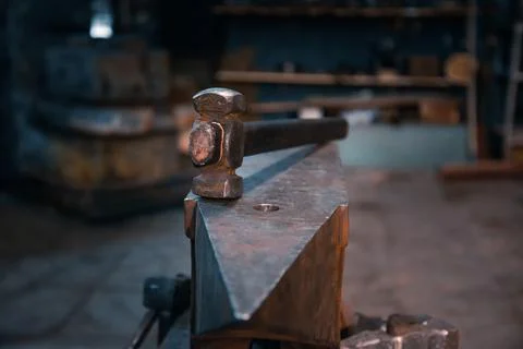 Hammer on an anvil in a forge, general view. Stock Photos