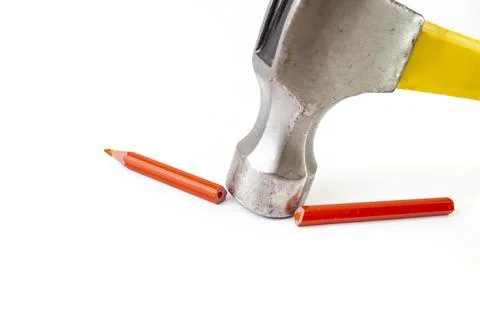 Hammer breaking a red crayon in two pieces, isolated on white background Stock Photos