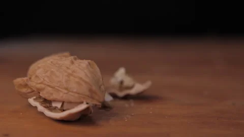 Hammer breaking walnut slow motion Stock Footage 148336004