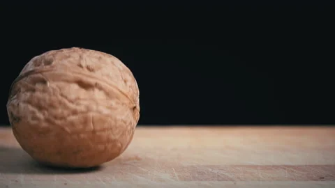 Hammer Cannot Break the Walnut on a Black Background Stock Footage 200809456