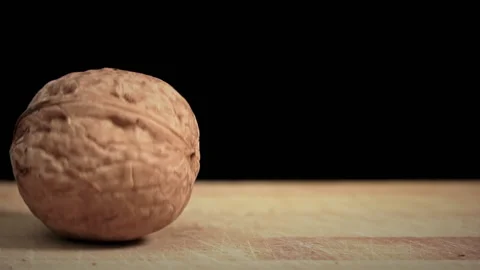 Hammer Cannot Break the Walnut on a Black Background Stock Footage 200834531