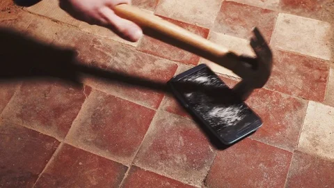 Hammer crash hitting a smartphone, broken touch screen glass slow motion rapid Stock Footage 83834178