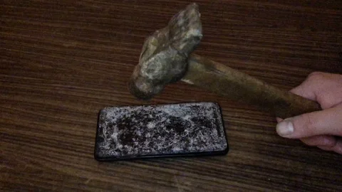 Hammer crash hitting a smartphone, broken touch screen glass. Stock Footage 124384755