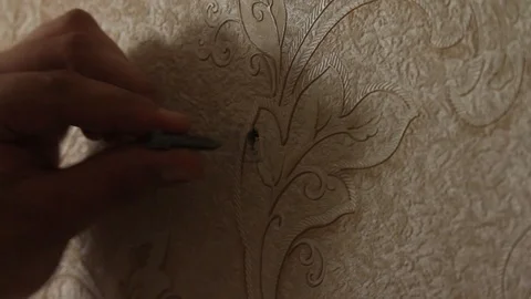 Hammer a dowel into the wall Stock Footage 97716547