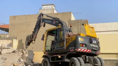 Hammer Drill Excavator large working on construction site breaking concrete Stock Footage 295125292