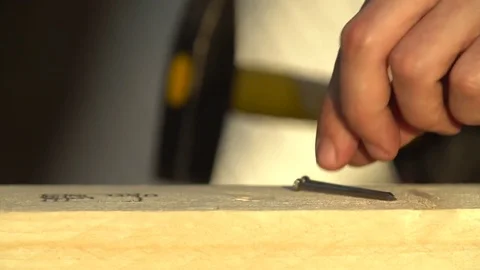 The hammer hammers a nail in two or four strokes in slow motion Stock Footage 83327048