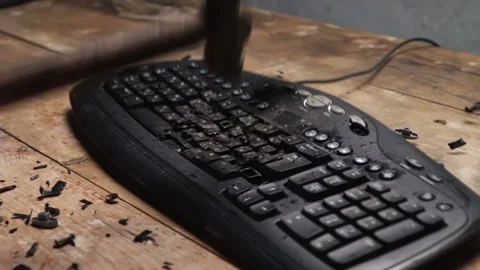 Hammer hitting computer keyboard. Damage keyboard. Broken office equipment. Stock Footage 166972475