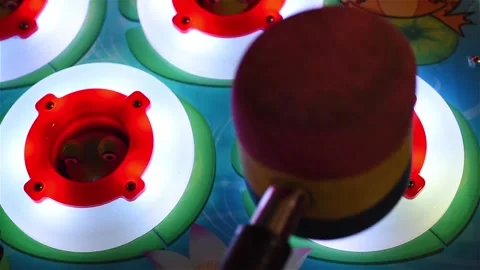 Hammer hitting crazy frogs inside holes Stock Footage 221804436