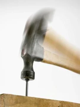 Hammer hitting nail Stock Photos