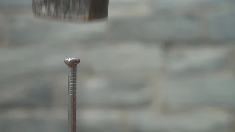 A Hammer Hitting a Nail in Slow Motion, Close up Stock Footage 90515259