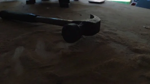 Hammer Landing in Sawdust on Workshop Table Stock Footage 97085779