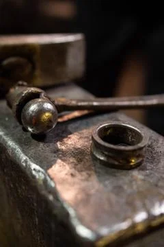 Hammer lying on a forging in a forge Stock Photos