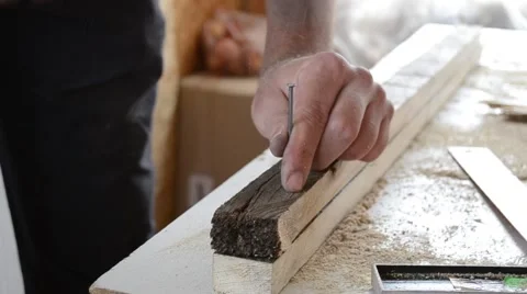 Hammer nails into a board Stock Footage 67286733